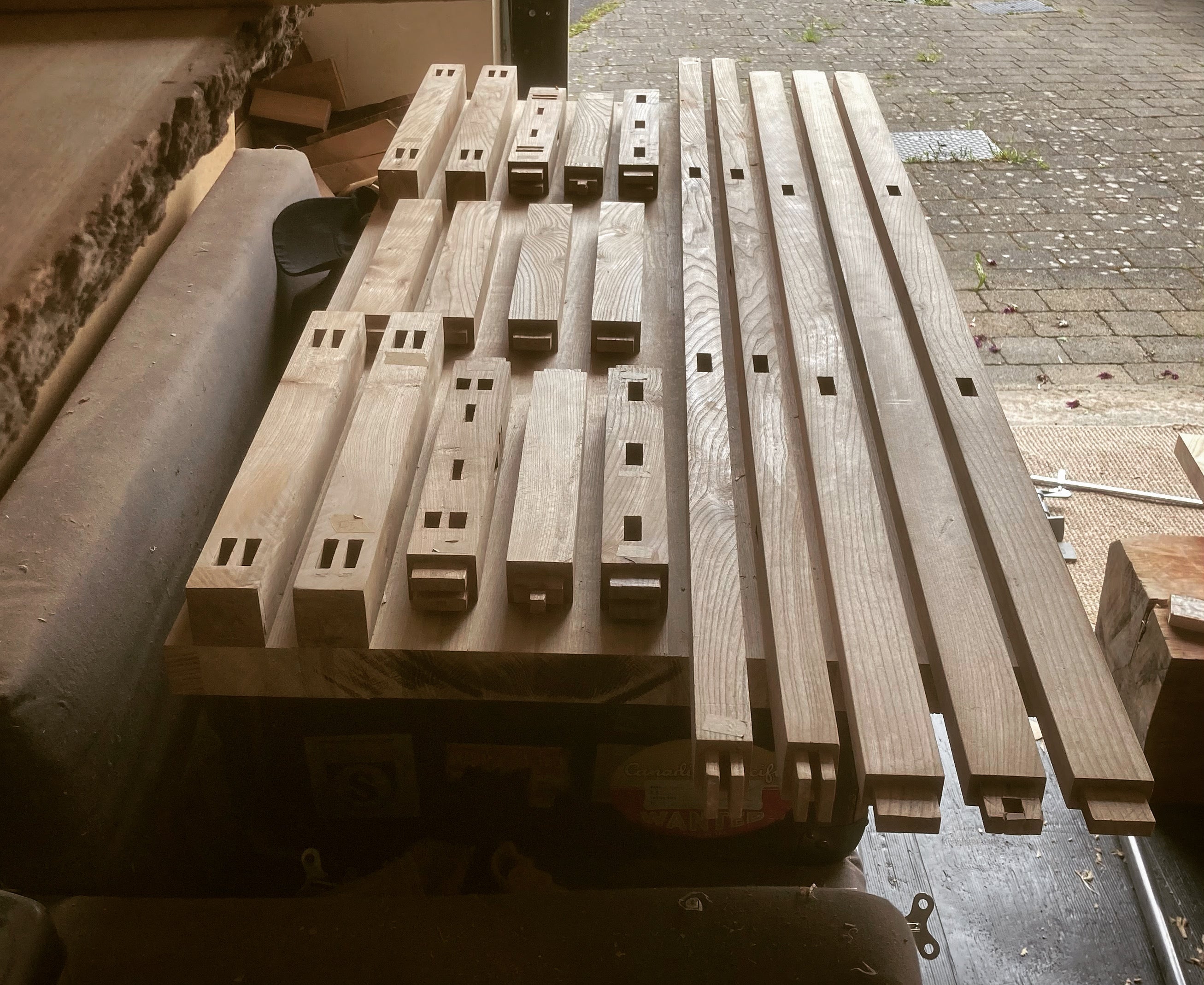 Hand sawn bench components with hand cut mortise and tenon joinery in Scottish Elm 
